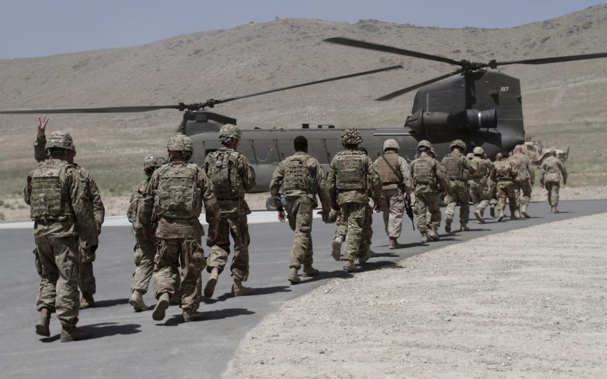 NATO solders walk towards a Chinook helicopter after a ceremony at a military academy on the outskirts of Kabul, Afghanistan, Tuesday, June 18, 2013. Afghan forces have taken over the lead from the U.S.-led NATO coalition for security nationwide, Afghanistan President Hamid Karzai announced in the significant milestone in the 12-year war. (AP Photo/Rahmat Gul)